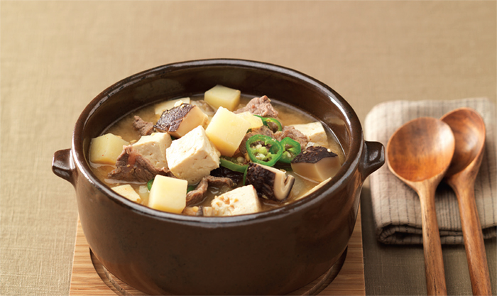 Doenjang Jjigae (Soybean Paste Stew). This stew-like Korean dish is made by boiling an assortment of ingredients such as meat, clams, vegetables, mushrooms, chili, tofu, and soy paste.